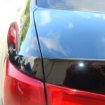 Before and after photographs of a damaged black Volkswagon Jetta that was repaired by Elite Paint & Body Shop in West Palm Beach, Florida.